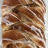 A picture of an apple cream cheese Danish braid with glaze drizzled on top.